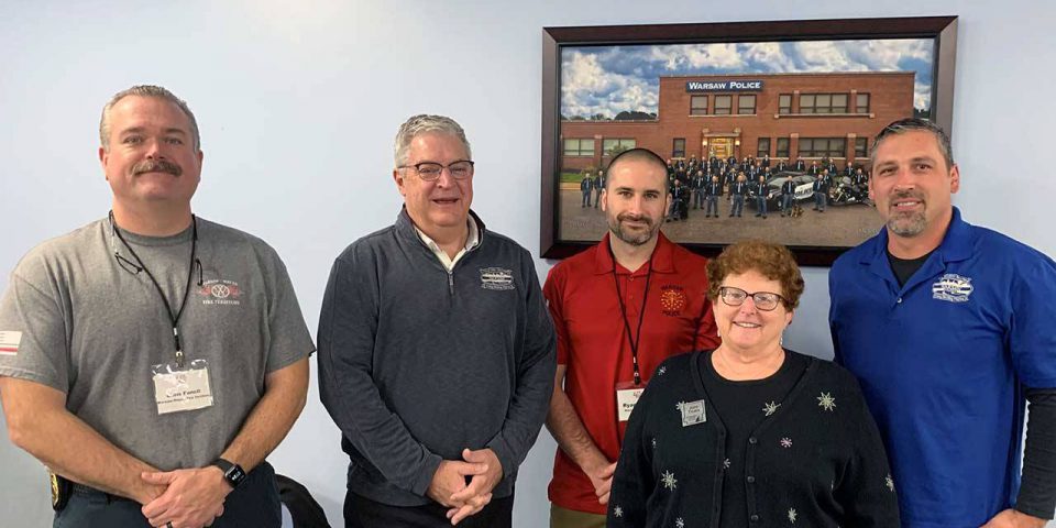 Kosciusko Leadership Academy group photo of five adults in the Warsaw Police department.