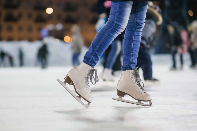 KLA ice rink project displayed by a skater wearing jeans and white ice skates